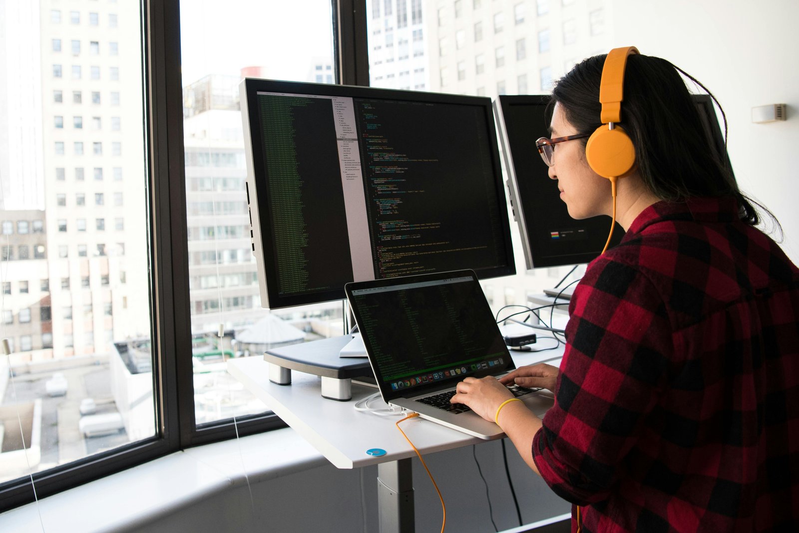 Person at a multi-monitor desk during a long screen session