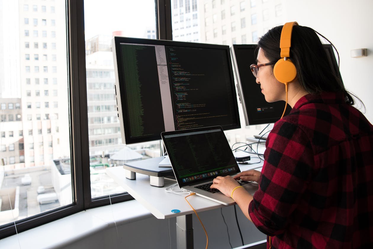 Person at a multi-monitor desk during a long screen session